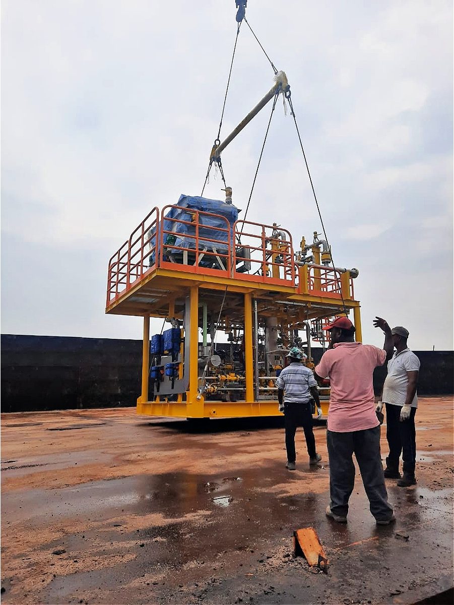 large fuel gas pump on skid being delivered by crane